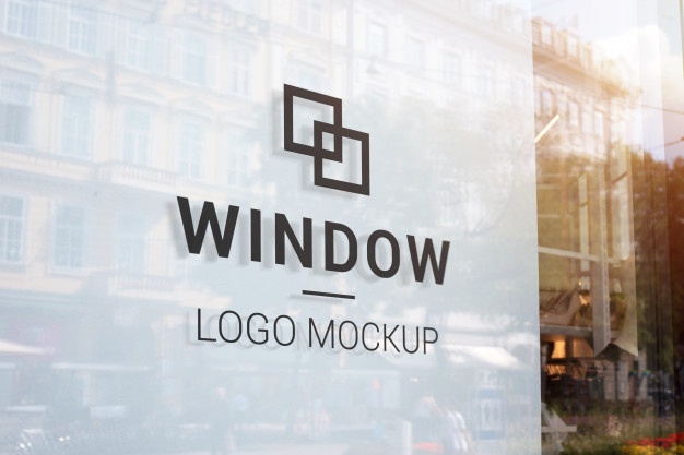 black-logo-mockup-store-window-with-white-indoor-modern-street-shop-window-city-center-buildings-sun-light-reflection_176814-157